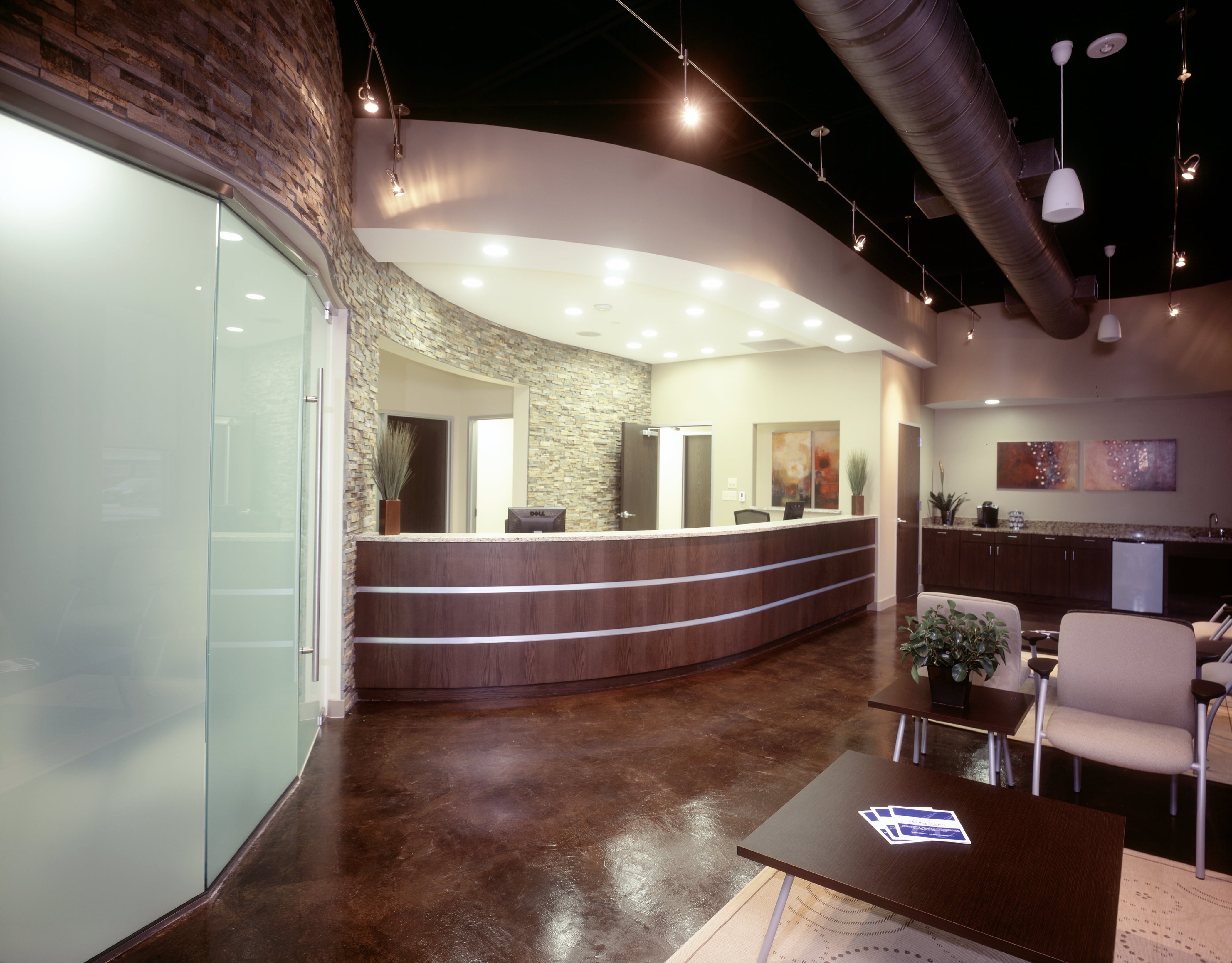 Norstone Ochre Stacked Stone Veneer Rock Panels on radius wall behind reception desk of medical office